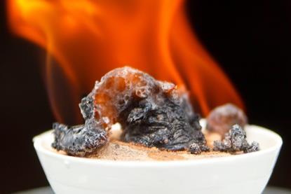 An image of sugar burning in an evaporating dish
