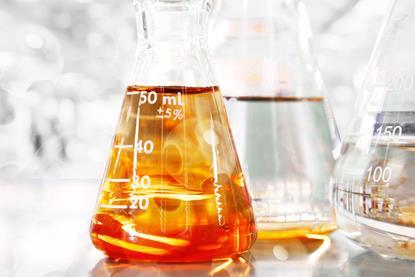 Conical flask with orange liquid image