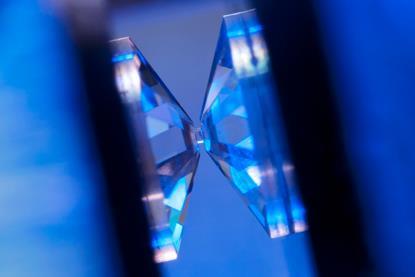 A crystal is placed under high pressure between two diamond tips in a diamond anvil cell