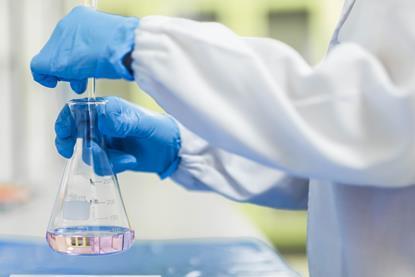person in a lab conducting a titration