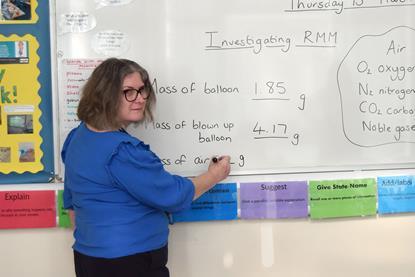 A teacher in front of a white board