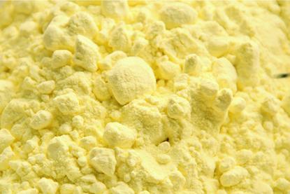 A close-up photograph of yellow sulfur powder