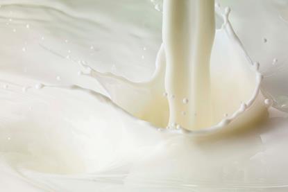 A close-up image of milk and a splash where more milk is poured or added