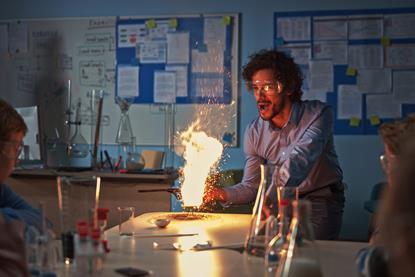 A chemistry teacher burning something in a practical class