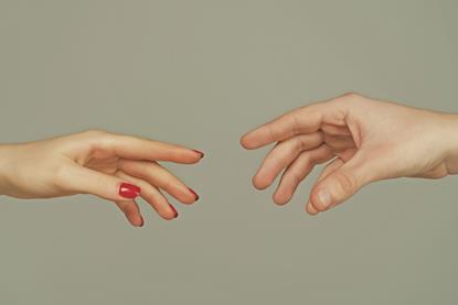 Two people unable to shake hands because they are offering mirror image hands