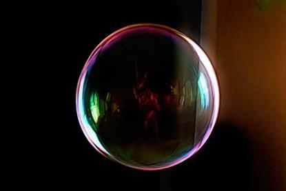 A close-up enhanced image of a soap bubble against a black background