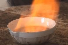 Evaporating dish containing burning hydrogen peroxide and ethanol
