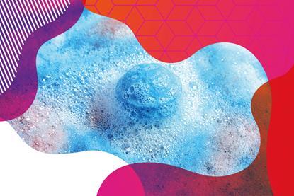 photo of a blue bath bomb surrounded by blue and pink bubbles