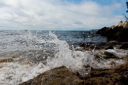 Seawater splashing against a rocky shore