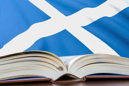 Open book with a Scottish flag behind it