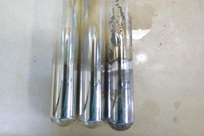 Three glass tubes containing silver deposits resulting from Tollens' test, or the silver mirror test, used to distinguish between aldehydes and ketones