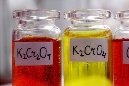 Aqueous solutions of red potassium dichromate and yellow potassium chromate in glass jars