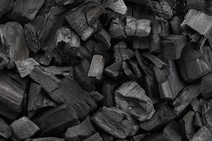 A close-up, full-frame photograph of pieces of charcoal