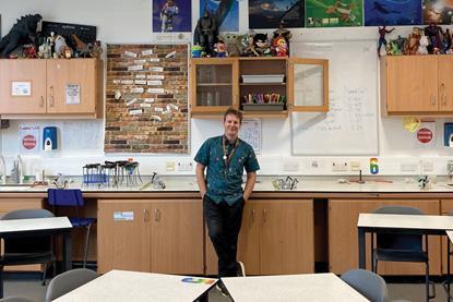 A chemistry teacher in a science classroom