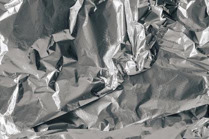 A close-up photograph of wrinkled silver aluminium foil