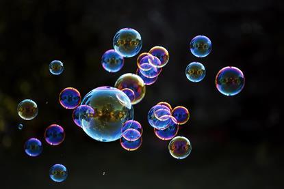 Bubbles of different sizes floating against a black background