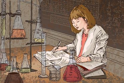 A female teacher marking exams in a classroom surrounded by laboratory glassware