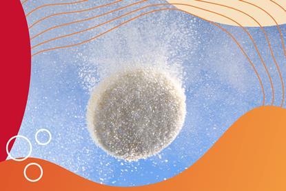 Closeup of effervescent pill dissolving in water