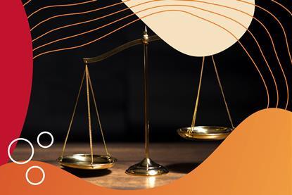 A brass pan balance with red-orange graphic surround