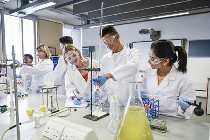 Chemistry student carries out a titration in a school laboratory