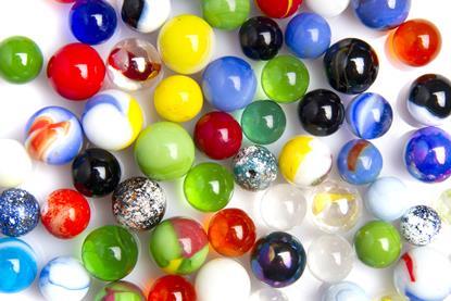 A group of spherical marbles of different sizes and colours