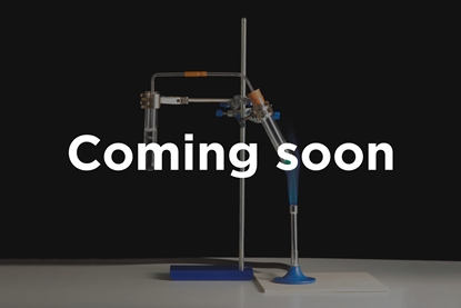 A photograph of two boiling tubes connected by a tube, with one suspended over a Bunsen burner. Superimposed text reads "Coming soon".