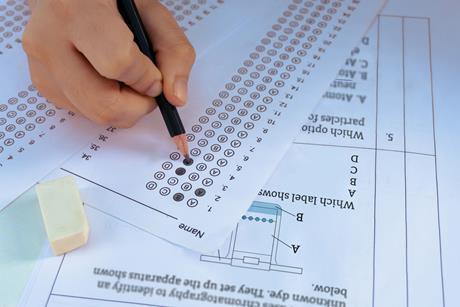 A student answering a multiple choice chemistry questions with a pencil