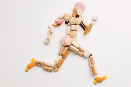 A picture of a running man made up of vitamin supplements