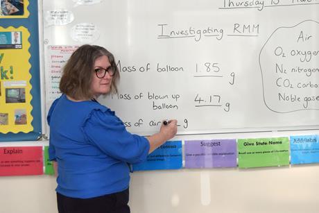 A teacher in front of a white board
