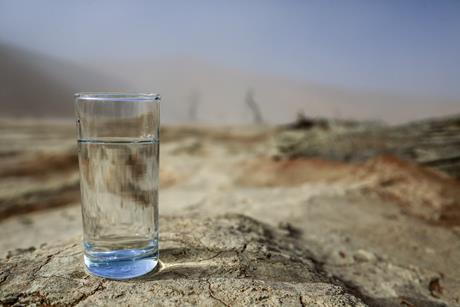 Picture of a glass of water in a desert
