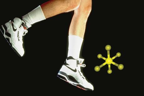 A dated photograph showing a man's legs wearing Nike air and kicking sulfur hexafluoride