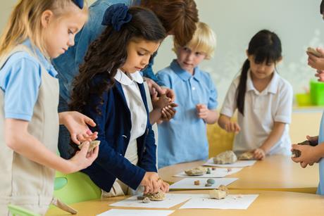 A group of primary school pupils examine different types of rocks
