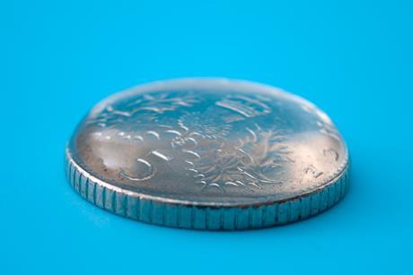 A drop of water balanced on a five-pence piece