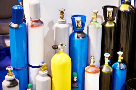 picture of lots of metal cylinders with compressed gas inside