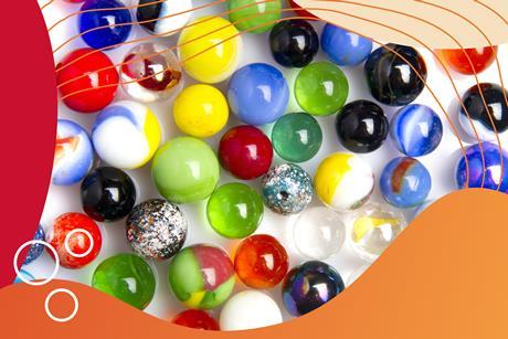 A group of spherical marbles of different sizes and colours