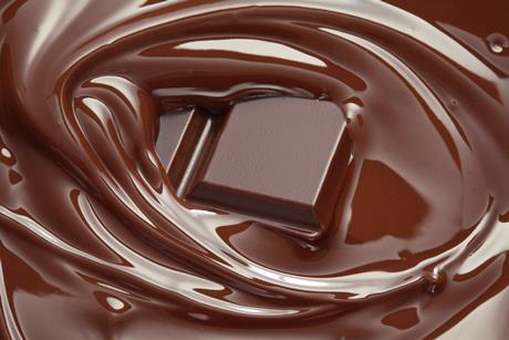 picture of chocolate melting with a square of chocolate in the middle of melted chocolate