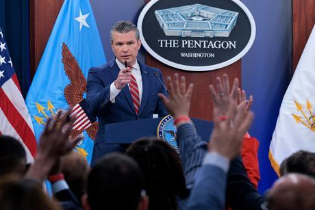 U.S. Secretary of War Pete Hegseth calls on reporters who have their hands raised with questions during a press briefing at the Pentagon
