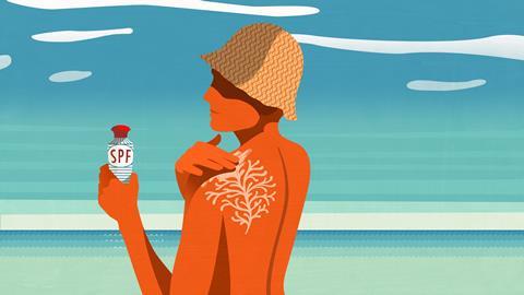 An image showing a person on the beach applying sunscreen on their skin, which looks like a piece of coral on their back