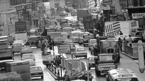 A black and white photo of a traffic jam in London in the 1970s