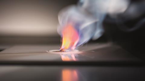 Potassium burning orange and red in water