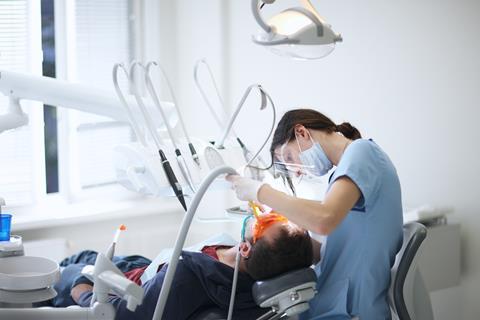 An image showing a dentist at work