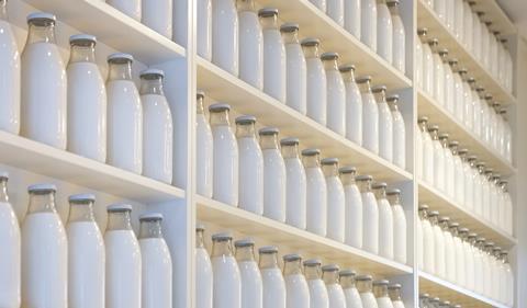 An array of milk bottles on shelves