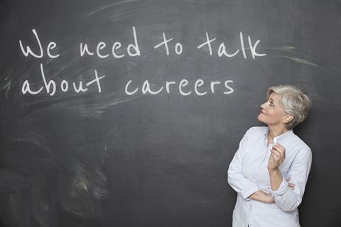 A picture showing a teacher looking at a blackboard with 'We need to talk about careers' written on it