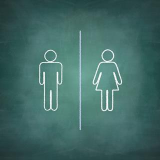 Male and female stick figures on a chalk board