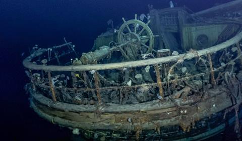 Underwater photo of a shipwreck showing the helm