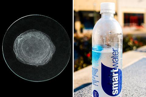 A watchglass with some crystals left by evaporation and a bottle of mineral water