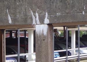 A concrete stalactite formed on the concrete outside a car park