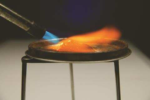 Bunsen burner lighting a pile of zinc and copper oxide