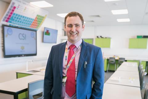 Portrait of chemistry teacher Ed Kelly in his classroom