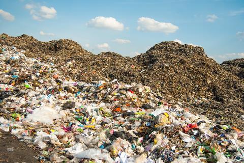 A photo of a landfill with a mountain of plastic waste